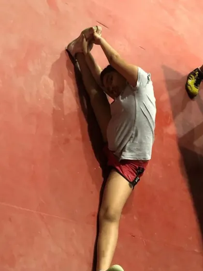 A player performing an advanced stretch. We incorporate dedicated flexibility work into our training regimen to enhance athletic performance and reduce the risk of injury.