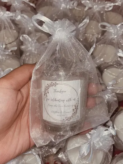 I love creating these simple yet elegant wedding favors. These mini jar candles are wrapped in organza bags with a custom "Thank You" tag for the couple, Connie and Cliffton.