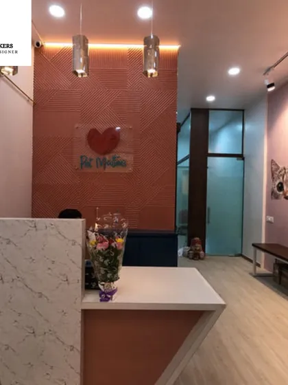 For this pet boutique, the goal was to create a warm and welcoming reception that felt both modern and playful. The design combines a textured feature wall, sleek lighting, and a marble-finish counter to establish a professional yet friendly brand identity.