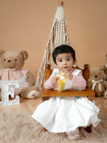 A high-chair portrait is a classic for a first birthday, capturing the little one as the guest of honor in their special celebration.