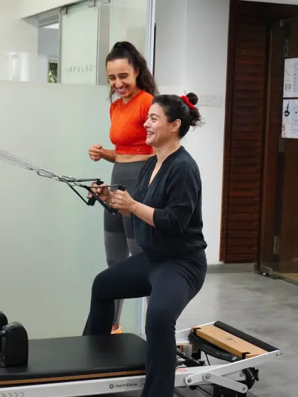 The joy of movement is at the heart of what we do. Kajol's smile says it all as she works her arms and core on the reformer, proving that getting stronger can be an enjoyable and rewarding process.