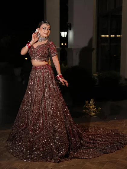 The sparkle of this fully embellished lehenga is captured perfectly in this evening shot. It’s an ideal choice for a bride who wants to shine all night long.