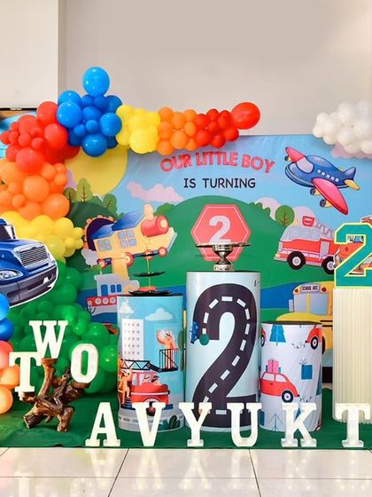 A magical 'Mermaid' themed birthday party, with shimmering blue and green decor, seashell props, and mermaid cutouts, creating an enchanting underwater world.