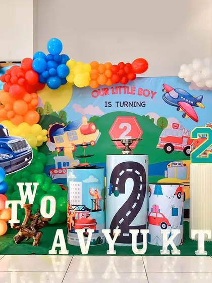 A vibrant and fun transportation-themed second birthday party, featuring cars, trucks, and planes.