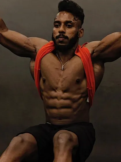 The "after" shot, showcasing a shredded and muscular physique. This client is a men's physique competitor who successfully completed a bulking and cutting cycle.