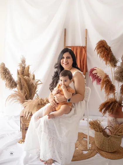 A mother and her baby in our earthy, boho studio setup. The natural textures and warm tones create a relaxed and stylish family portrait.