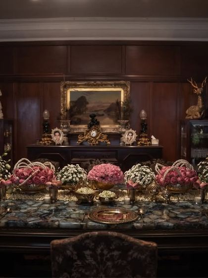 A wider view of the opulent dinner setting, showing how the floral runner and gold accents create a luxurious and inviting atmosphere in the formal dining room.
