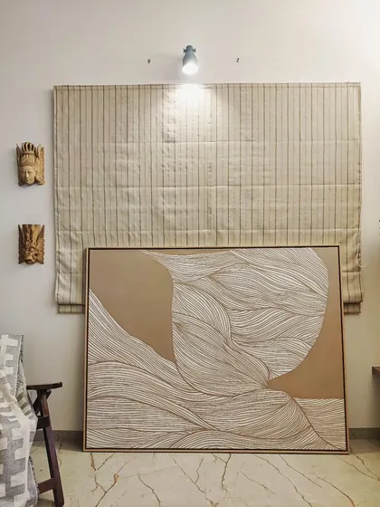 A large, minimalist statement piece created with intricate white line art on a neutral tan background. The flowing, organic lines add a sense of calm and movement, making it a perfect focal point for a serene living space.