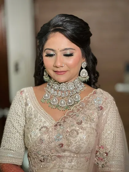 A close-up of the bride's makeup, with her eyes closed to show the soft shimmer on her lids.