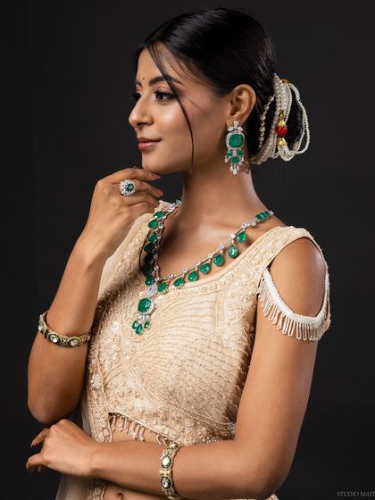 A profile shot of the model, highlighting her earrings and elegant posture.