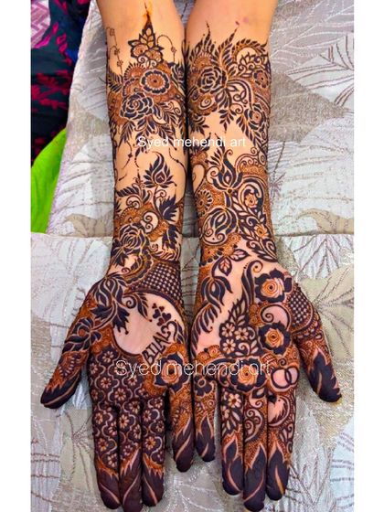 A full view of the intricate engagement design with names and rings.