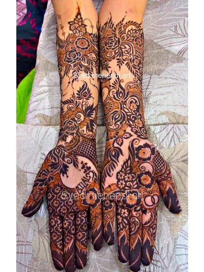A full view of the intricate engagement design with names and rings.