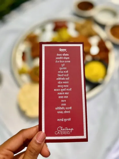 A personalized menu card for a Maharashtrian Pangat, written in Marathi. This small detail adds an authentic and personal touch to the traditional dining experience, listing all the delicious dishes to come.