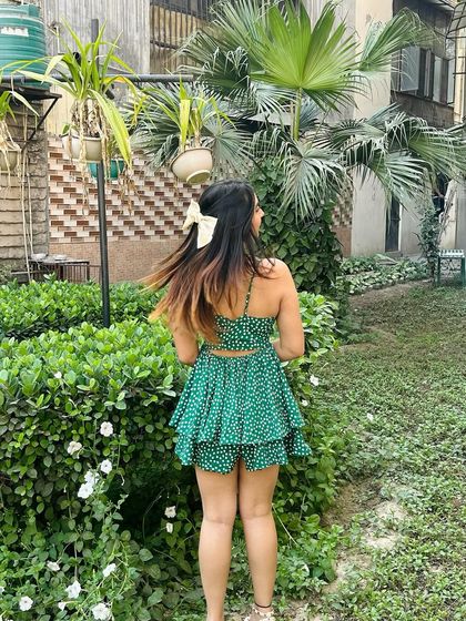 A back view of the romper, showing off the cute bow in my hair. I always pay attention to the little details that complete a look.