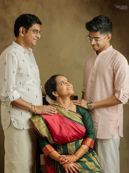 A beautiful family portrait celebrating a 25th wedding anniversary. The love between parents and their son is so evident.