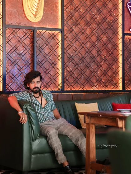 A collection of indoor portraits of an actor in a stylishly casual striped shirt. The moody lighting of the cafe setting adds a cinematic and modern feel, perfect for a character portfolio.