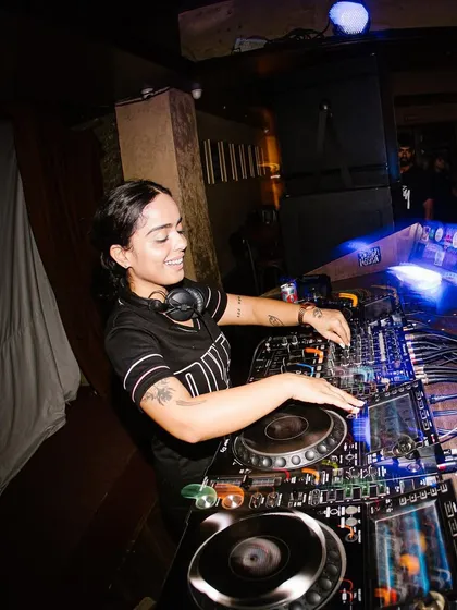 Another angle of me DJing, smiling and connecting with the crowd. I love what I do, and I think it shows in every performance.
