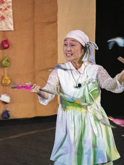 A close-up of the performer from 'Puppet Fantasy', her expression full of the joy and energy she brings to the stage.