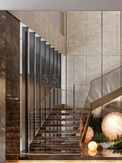 A detail of the staircase in an upcoming villa, showcasing a rich mix of materials. The design combines dark marble, textured stone walls, metal fins, and lush greenery with sculptural lighting to create a layered and luxurious experience.