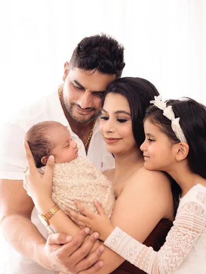A heartwarming portrait of a new family of four. The love and adoration for the new baby are palpable in this image.