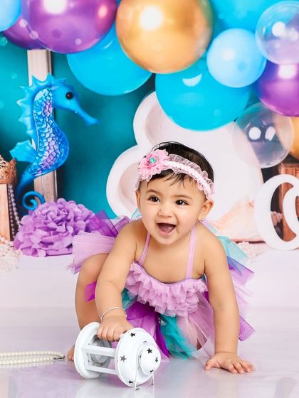 This little mermaid is on the move, exploring her magical sea-floor surroundings with a happy, energetic crawl.