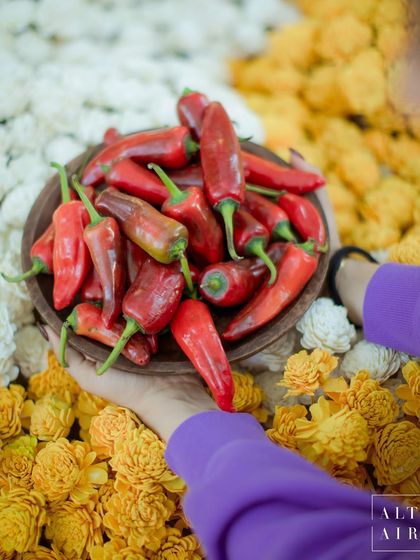 A bowl of fresh red chillies among a bed of marigolds at the 'Kesar Sehar' Haldi. This unexpected pop of color and texture is an example of how we love to play with traditional elements.