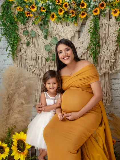 A heartwarming portrait of a mother and her daughter, eagerly awaiting the new baby. Including older siblings is a wonderful way to make them feel part of the journey.