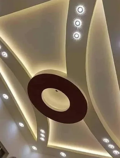 An elegant design with sweeping curves and a central circular element. The strategic placement of spotlights along the curves highlights the shape and adds a sparkling effect.