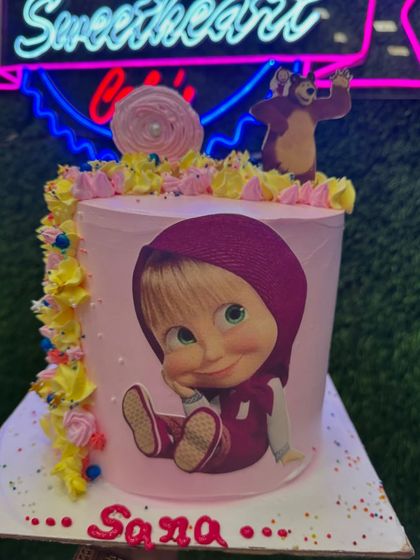 This Masha photo cake features a large, high-quality edible print of Masha. The simple design with colorful sprinkles is perfect for a fan's birthday party.