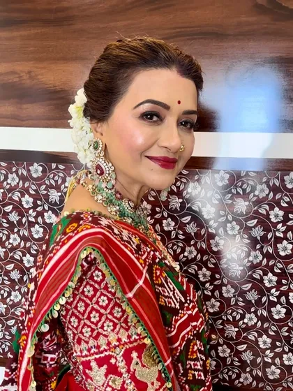 A profile view showing her radiant skin and the elegant floral bun, a perfect combination of traditional grace and modern makeup techniques.