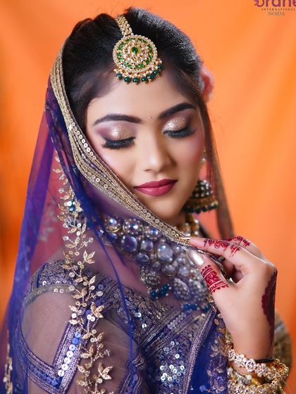 The delicate veil shot adds a layer of tradition and grace, while still showcasing the beautiful makeup underneath.