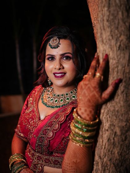 A close-up of Supriya's reception look. The bold purple and pink eye makeup is paired with a matching lip, creating a vibrant and memorable look.