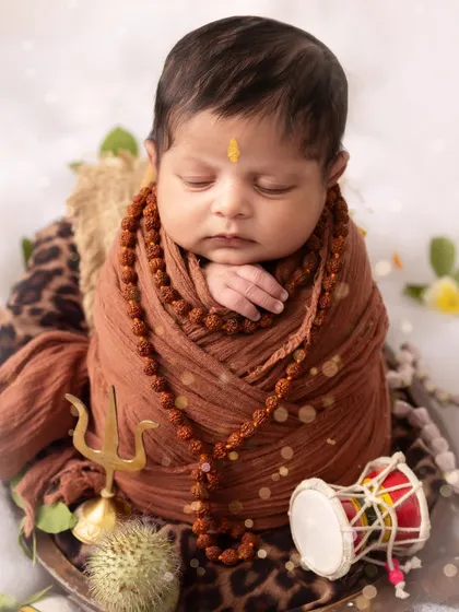 A peaceful, sleeping little Shiva, complete with a 'trishul' and 'damru'. Every detail is carefully placed to create a spiritual and artistic portrait.