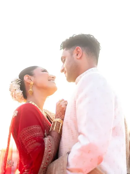 A close-up of the couple's happy expressions during their golden hour photoshoot. The focus is on their genuine connection.
