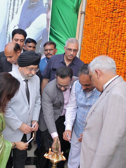 Participating in the traditional lamp lighting ceremony to inaugurate the Independence Day celebrations, a symbol of dispelling darkness with light.