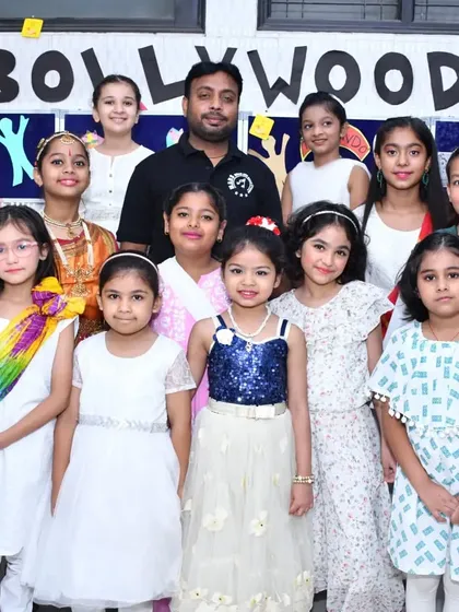 Our young dancers pose for a group photo at the 2023 closing ceremony. Dressed for their Bollywood performance, they represent the vibrant energy and diverse talent nurtured in our classes.