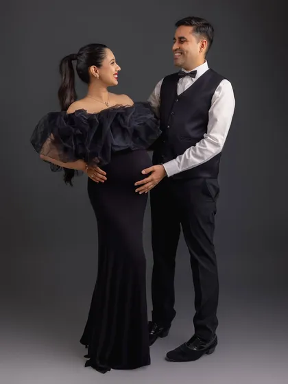 A formal and elegant couple's portrait. The black-tie attire contrasts beautifully, creating a sophisticated and timeless image.