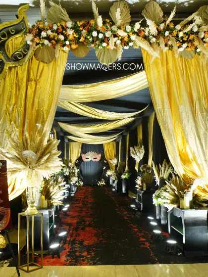 For a dramatic and glamorous Sangeet, we designed this stunning masquerade-themed entrance. The combination of black and gold draping, pampas grass arrangements, and intricate mask motifs creates a sense of mystery and excitement, welcoming guests to a night of high energy celebration.