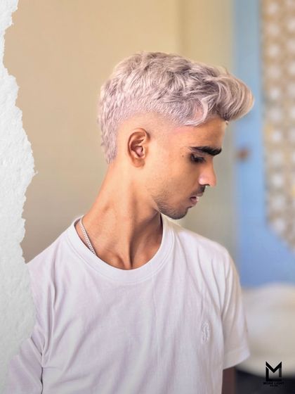 A custom ash color with a seamless fade. These images showcase the precision of our cuts and our skill in creating cool, modern ash tones that are perfectly blended.