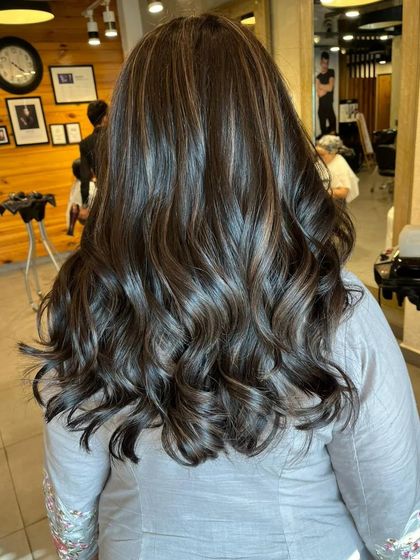 This is a classic brown balayage with soft, blended highlights. The result is super glossy and healthy-looking hair with just the right amount of dimension.