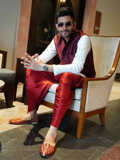 Indian weddings are a canvas of vibrant colors, and my outfits reflect that. Here, in a red and maroon dhoti set for a traditional ceremony.
