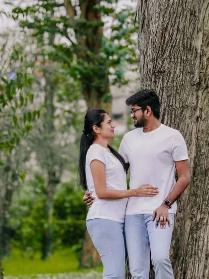 A simple and sweet portrait of a couple in a park, capturing a quiet moment together.