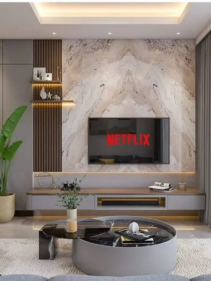 This living room showcases our ability to blend different textures and materials. We used a bookmatched marble-style panel for the TV unit, complemented by vertical wood fluting and a modern grey modular console, creating a focal point that is both grand and contemporary.