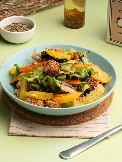 Another look at the Orange and Sesame Chicken Salad, highlighting the generous portion of sesame-coated chicken.