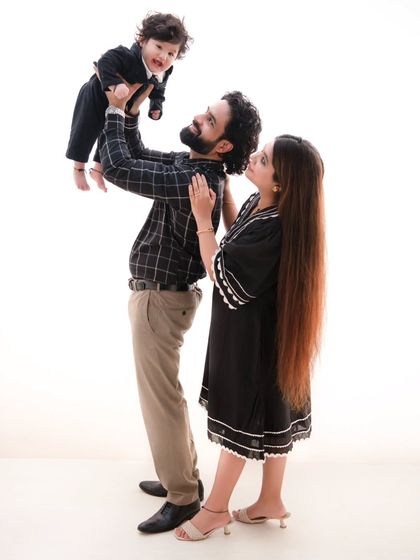 A moment of shared joy. I love capturing the interactions between family members, like the way this mother looks on as her husband plays with their son.