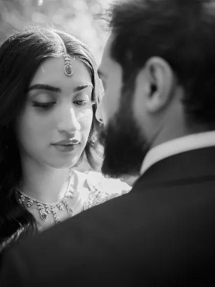 In the quiet moments, the most profound stories are told. This black and white portrait focuses on the gentle gaze and unspoken connection between a couple, stripping away everything but the pure emotion of their bond. It’s a testament to timeless, elegant love.