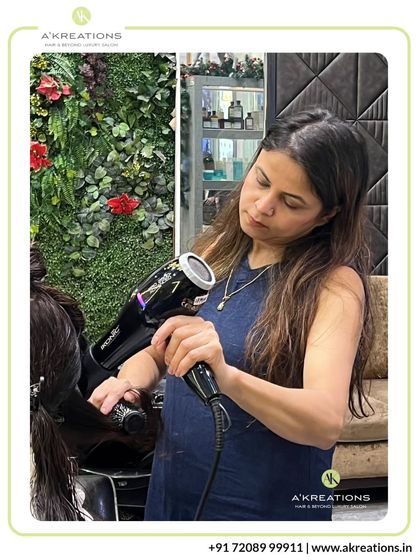 Creative Art Director Renukka using her expertise to create a flawless blowout, ensuring every strand is perfectly in place.