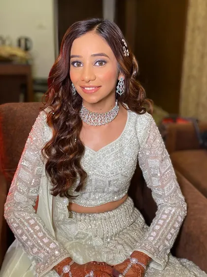 A happy and confident bride. Her makeup is fresh and glowing, making her look effortlessly beautiful.