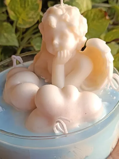 My angel and cloud jar candle is a dreamy, serene piece. It features a sculpted angel resting on fluffy wax clouds, all within a large glass jar with multiple wicks.