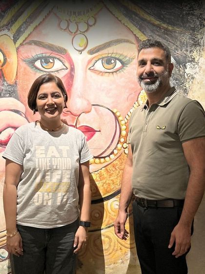 A proud moment with Chef Amninder Sandhu in front of our signature wall art after a successful collaboration.